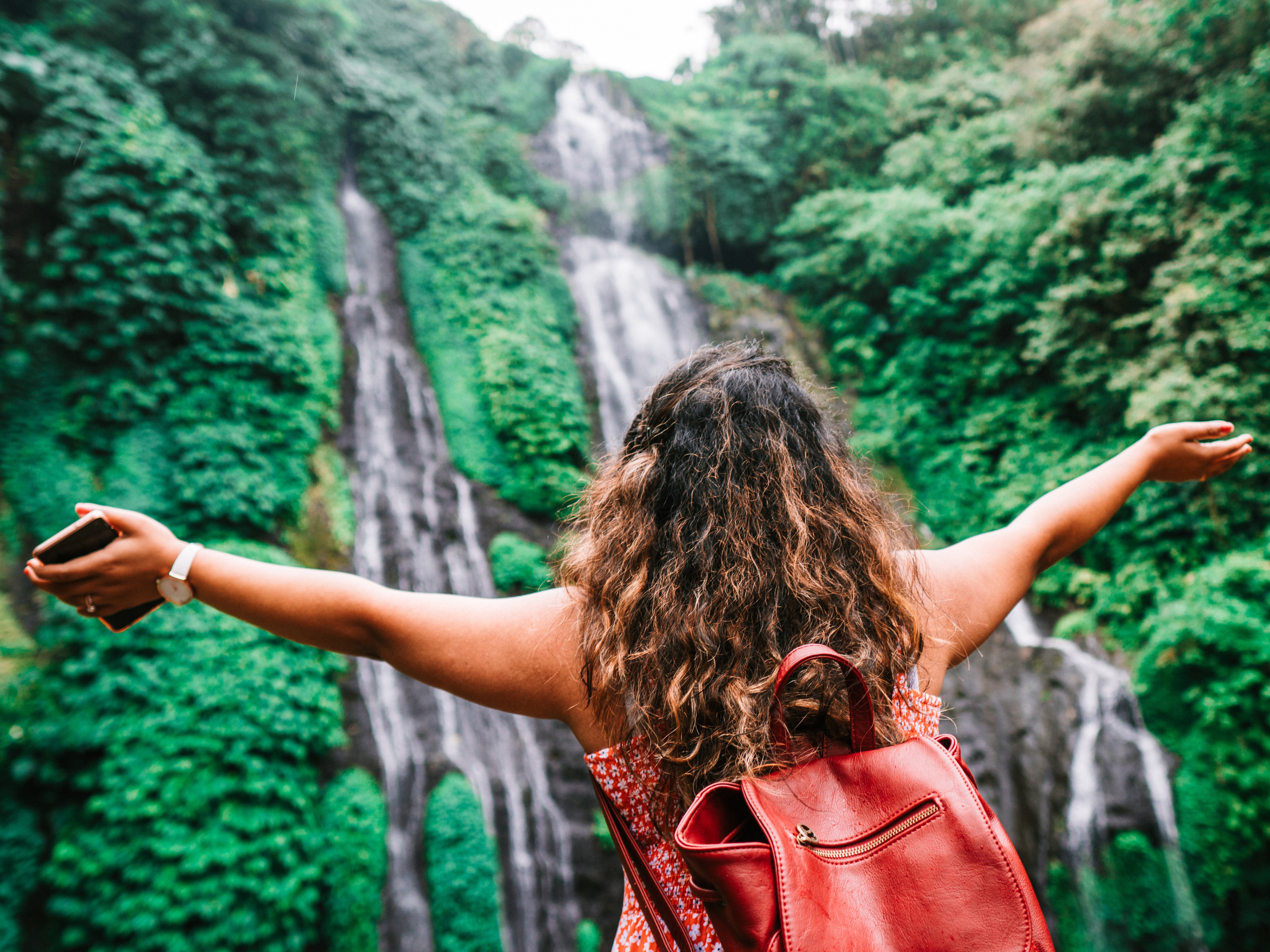 woman on bali waterfall tour at goddess retreat