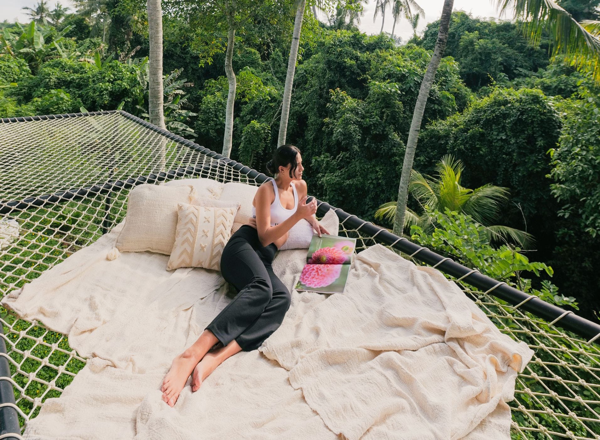 Woman seated in peaceful reflection at Yoga shala during a Bali retreat focused on emotional intelligence and self-awareness.