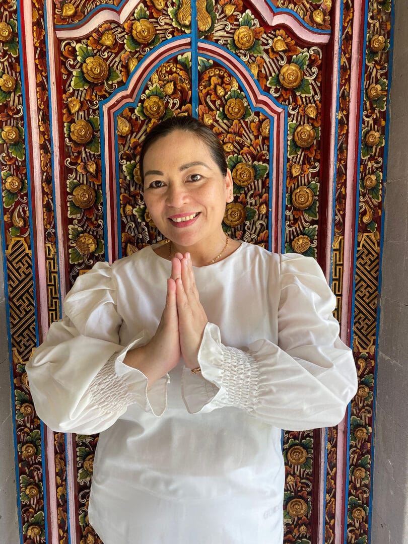 Dessy, hostess at Ubud retreat, staff member smiling and welcoming guests.