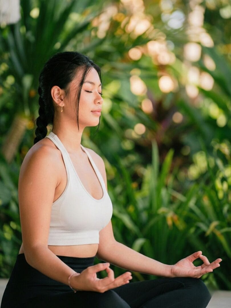 Close up of a woman practicing meditation during a women’s wellness retreat in Bali.