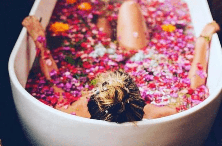 Tranquil bath experience at Goddess Retreats in Ubud, with lush greenery and serene surroundings, offering a peaceful atmosphere for relaxation and rejuvenation.